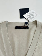 Light cream V-neck cardigan neckline with “LOUIS VUITTON” logo tag