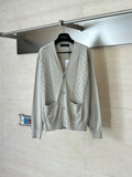 Light cream knit cardigan with V-neck, front buttons, and two chest pockets