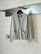 Light cream knit cardigan with V-neck, front buttons, and two chest pockets