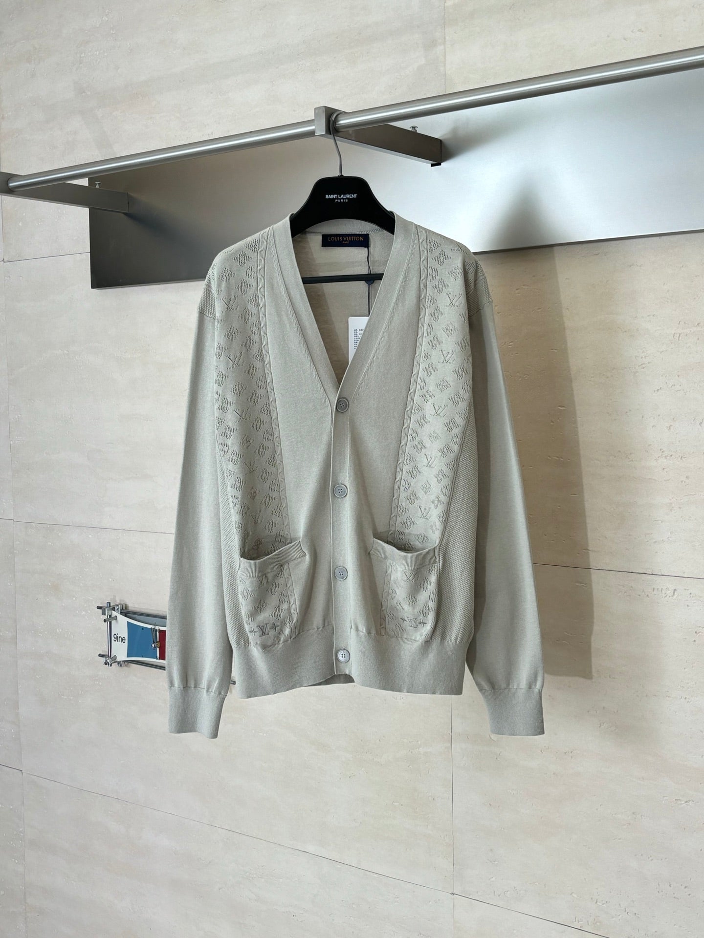 Light beige long-sleeve cardigan with V-neck, button front, and two chest pockets