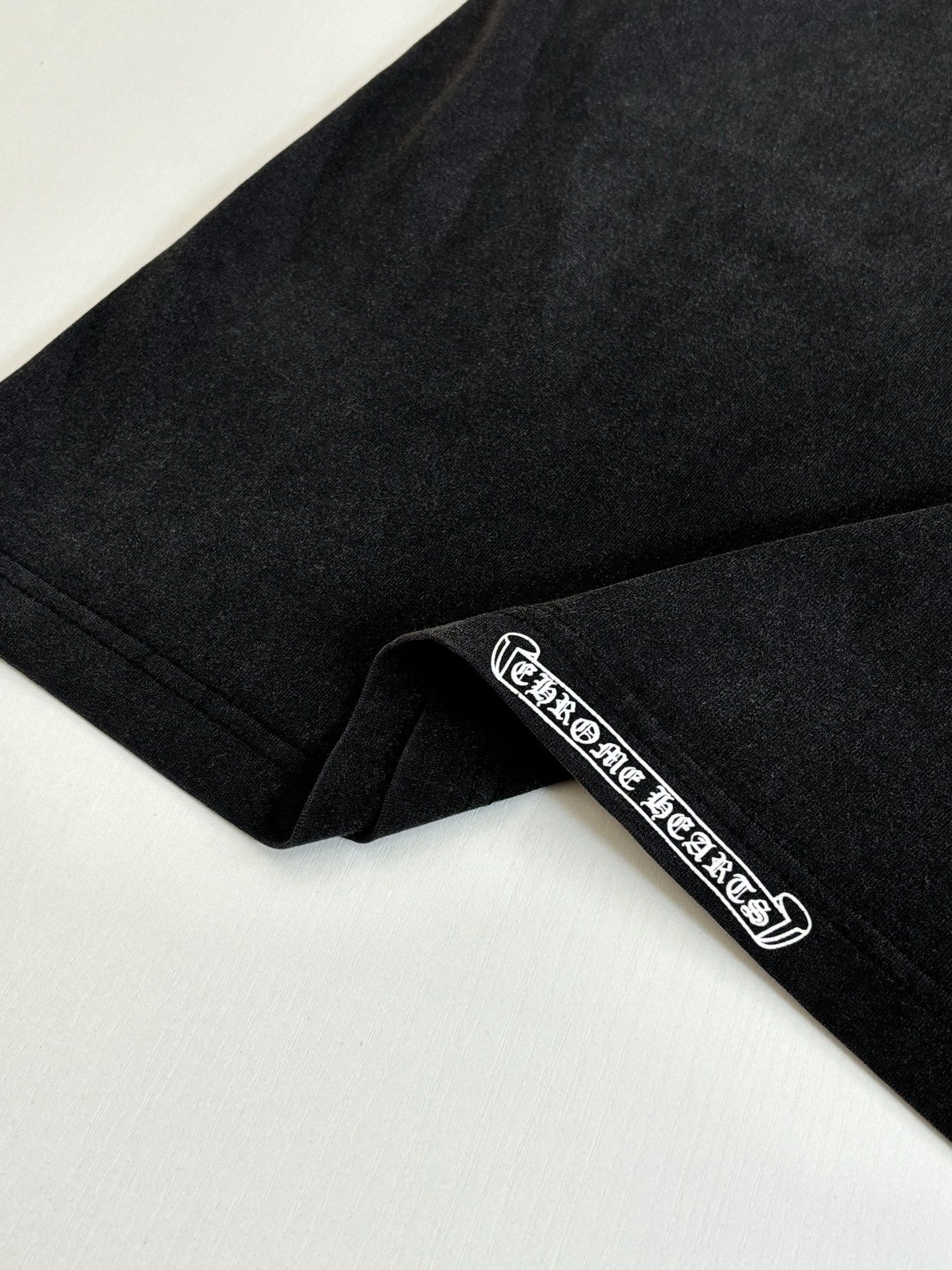 Black long-sleeve sweatshirt sleeve with embroidered logo stripe