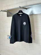Dark long-sleeve T-shirt with chest crest patch and small sleeve graphics