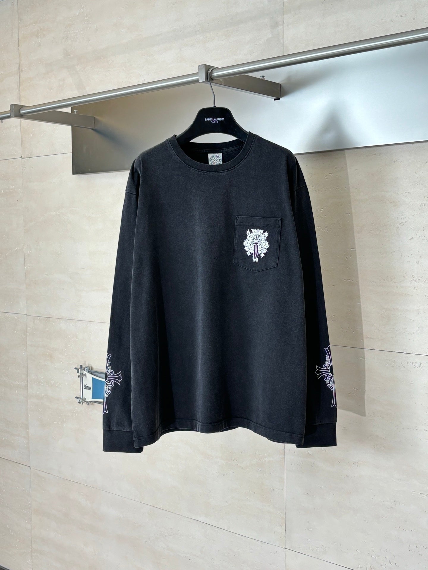 Black long-sleeve sweatshirt with front crest and side sleeve embroidery