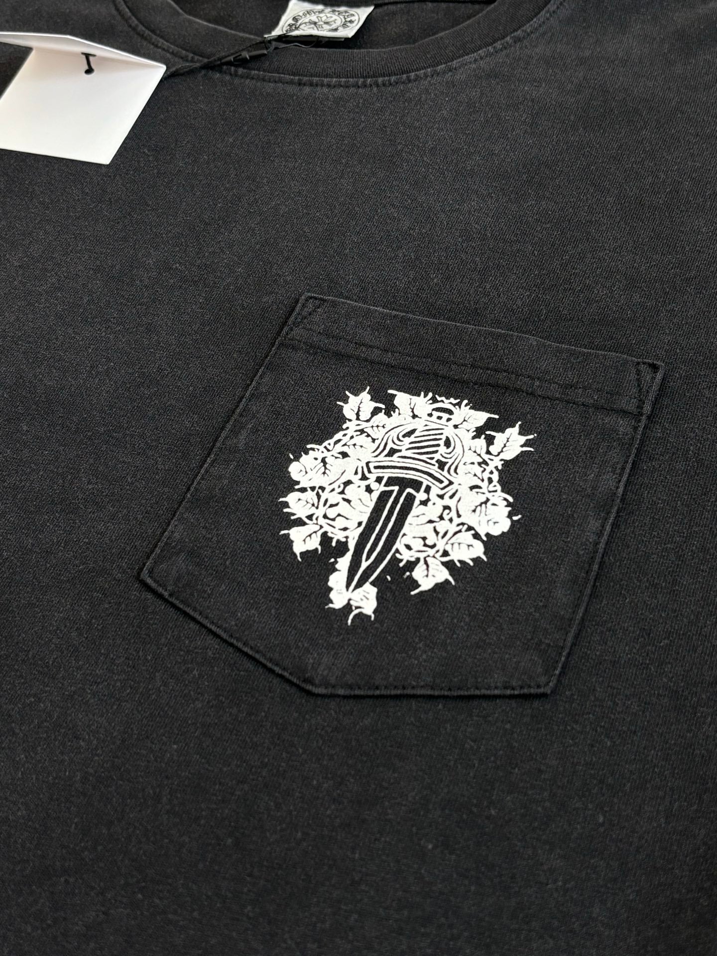 Dark long-sleeve T-shirt with large white graphic on chest pocket panel
