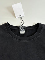 Black crewneck sweatshirt neckline with hang tag and embroidered chest crest