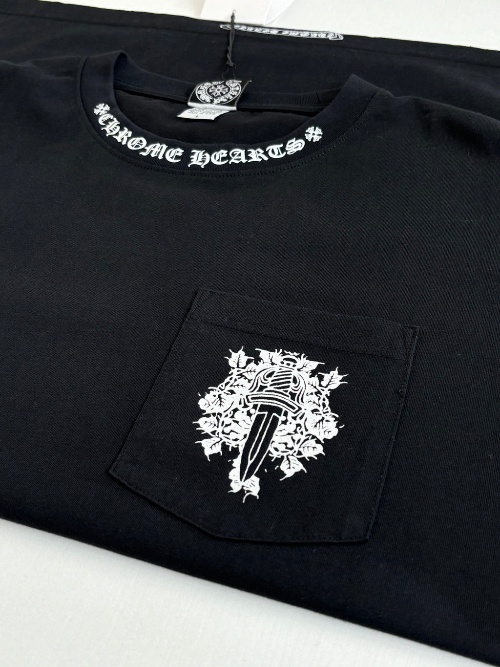 Black T-shirt with chest pocket panel and large white emblem print