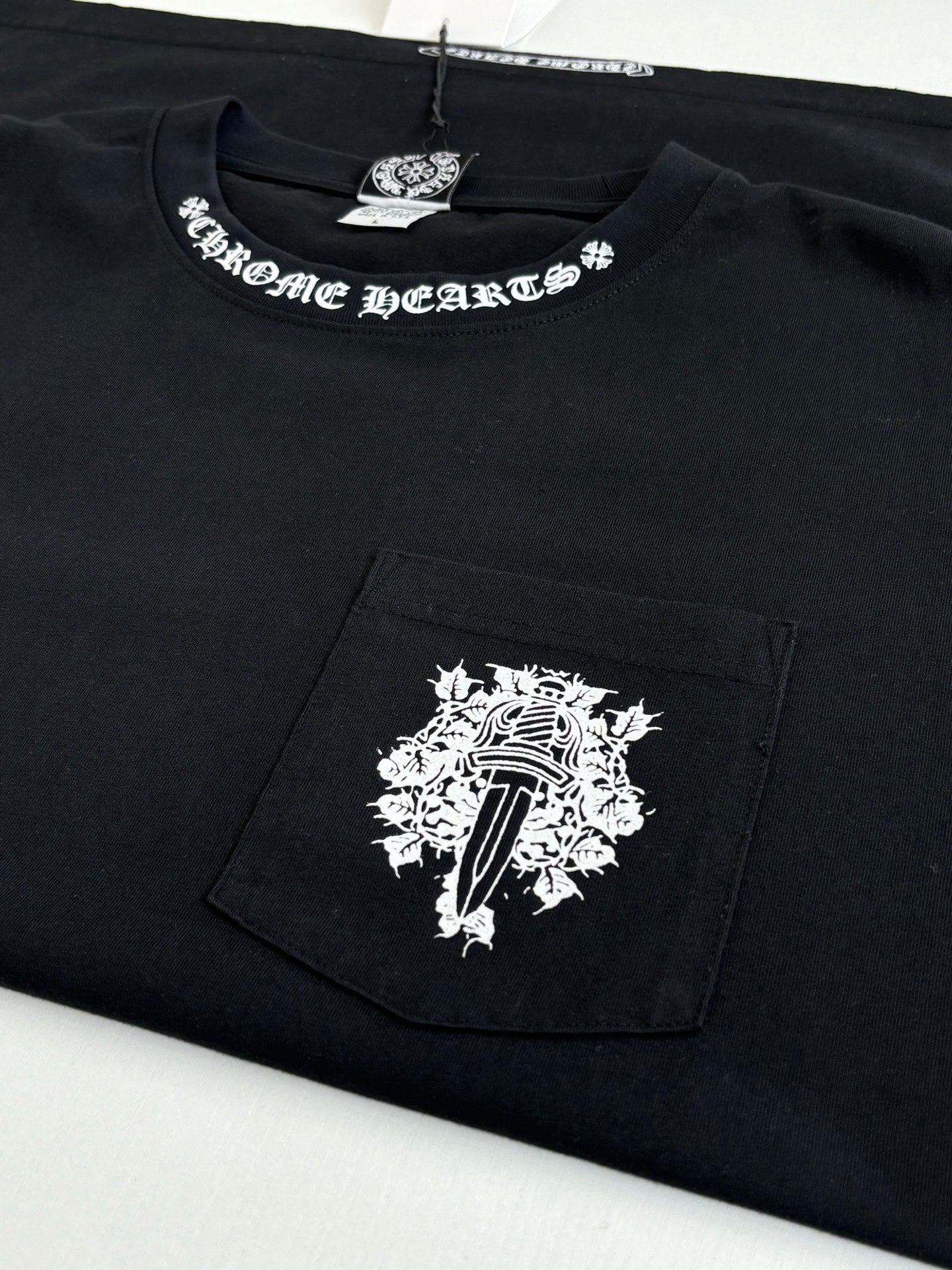 Black short-sleeve T-shirt with chest graphic on a front pocket panel