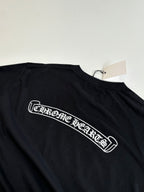 Black short-sleeve T-shirt with large script logo across the chest
