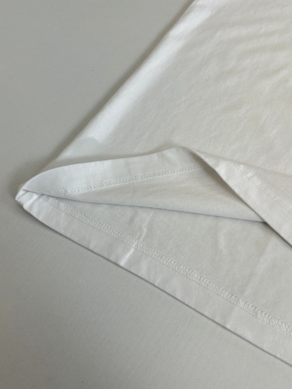 White T-shirt hem and side seam detail