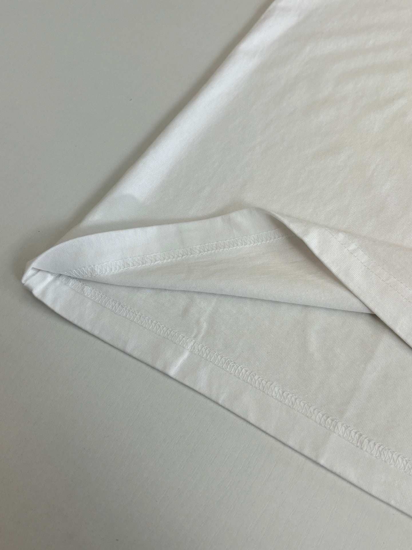 White T-shirt hem with stitched edge and clean finish