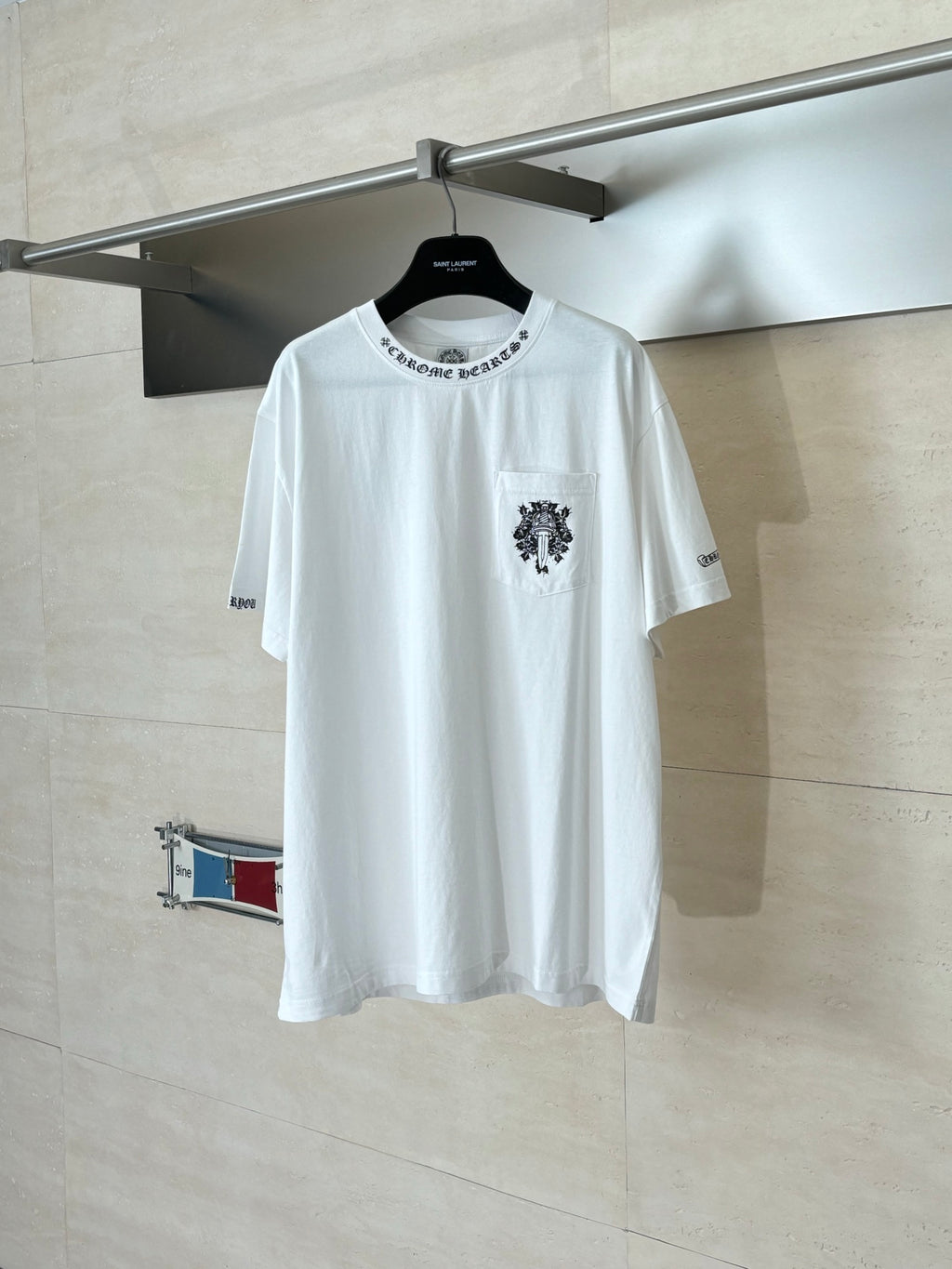 White short-sleeve T-shirt with chest logo patch and small sleeve print