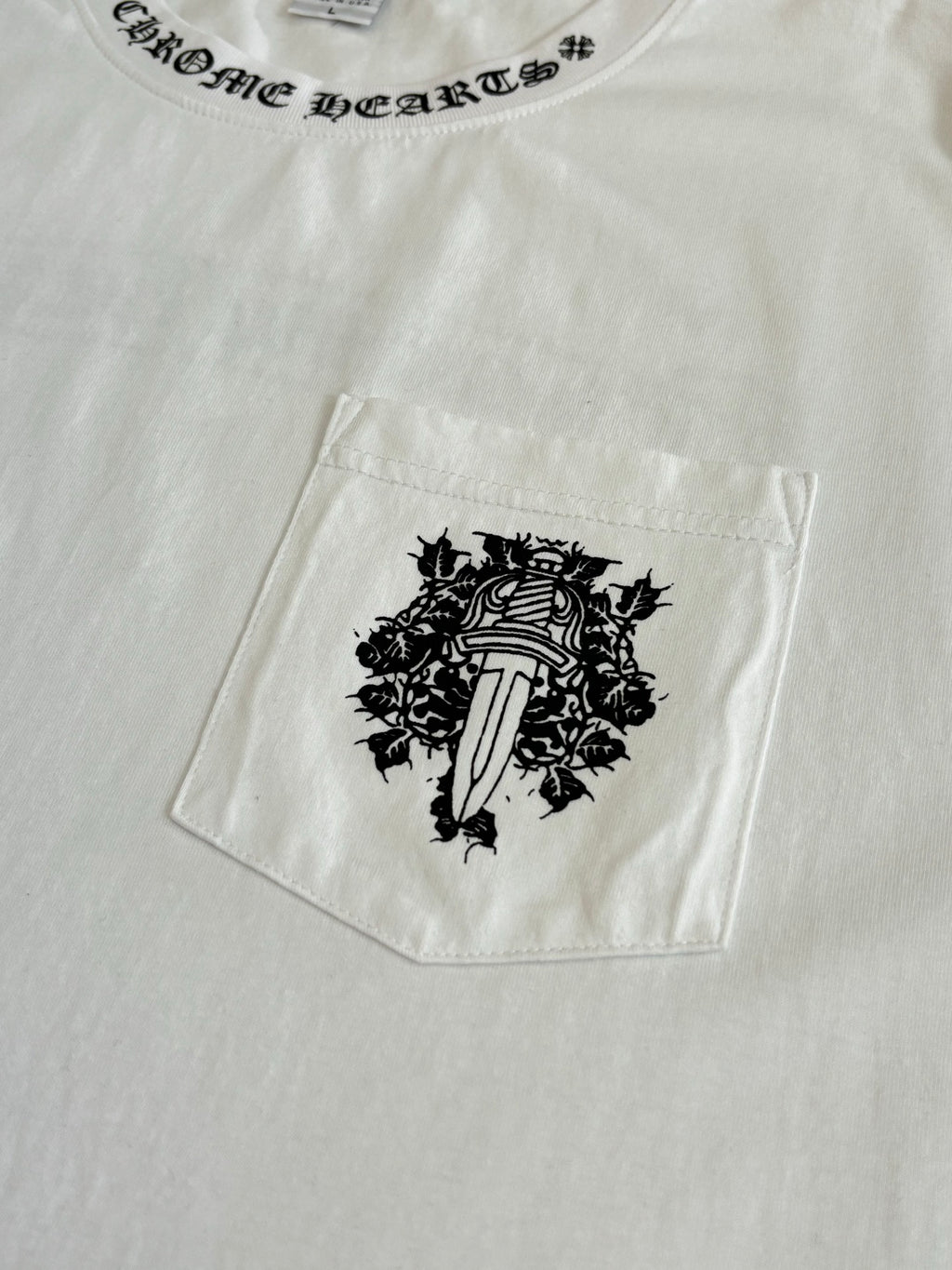 White T-shirt with front pocket and black crest graphic