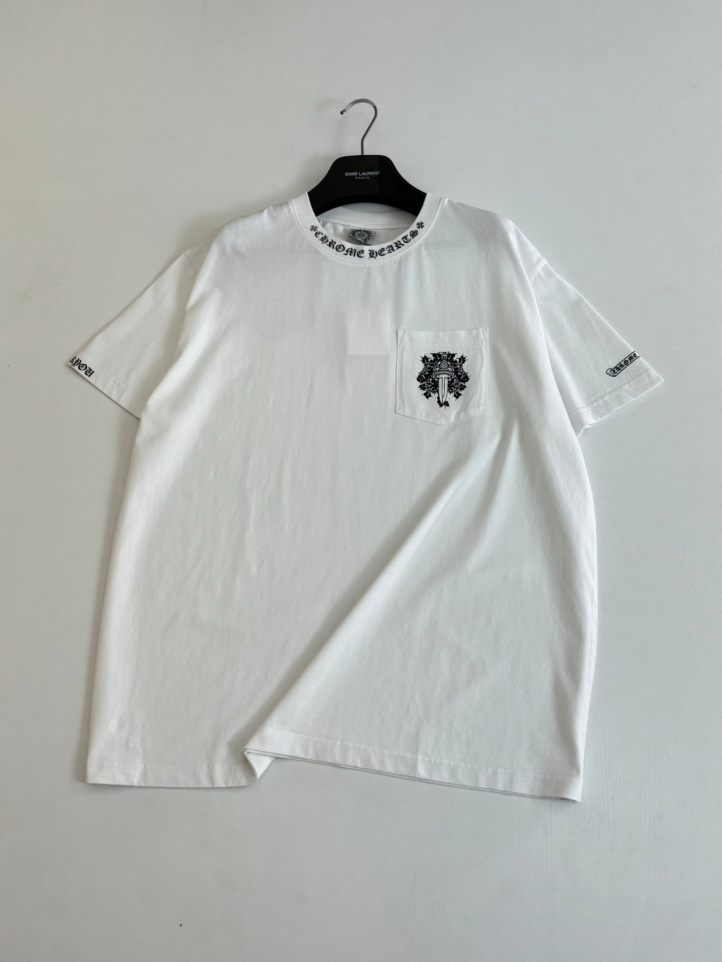 White crew-neck T-shirt with chest crest and sleeve text prints
