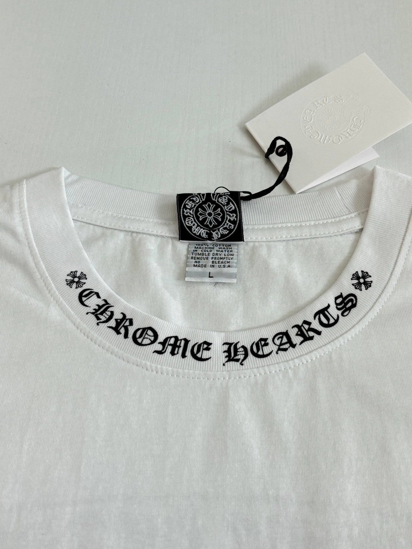 White crewneck T-shirt neckline with black printed collar text