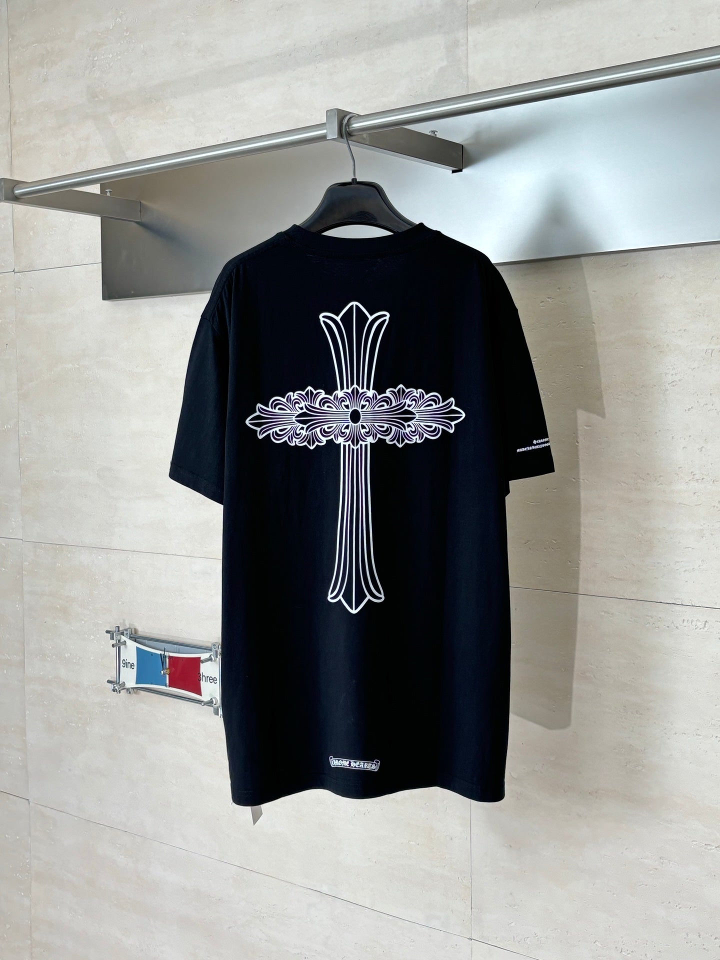 Black short-sleeve T-shirt with large back cross floral graphic
