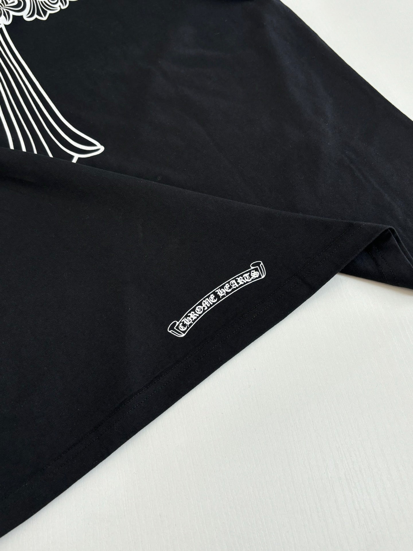 Black T-shirt with small side-hem logo text print