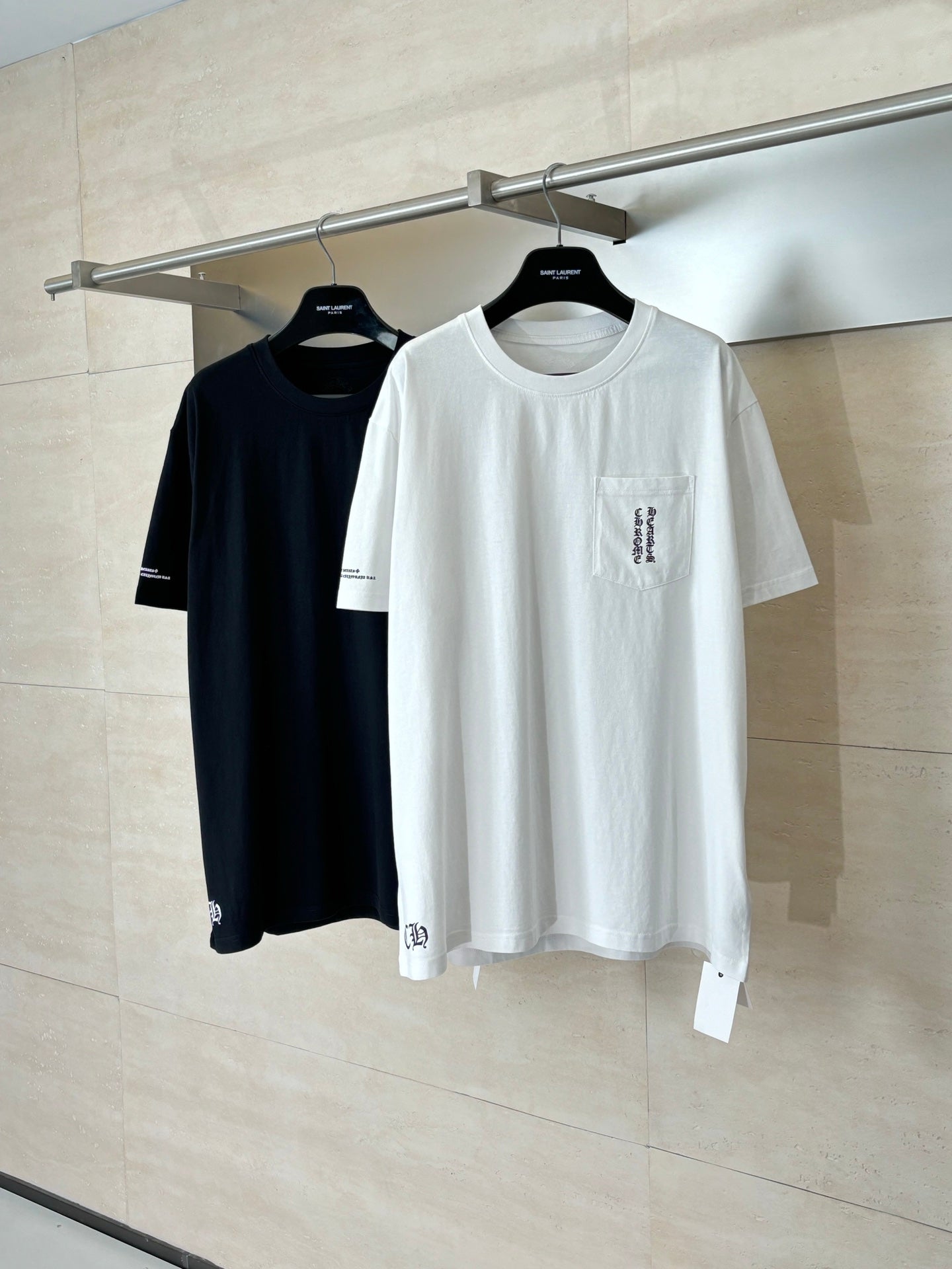 Pair of short-sleeve T-shirts on hangers: white and black, crew neck