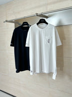 Short-sleeve T-shirts in black and white on hangers