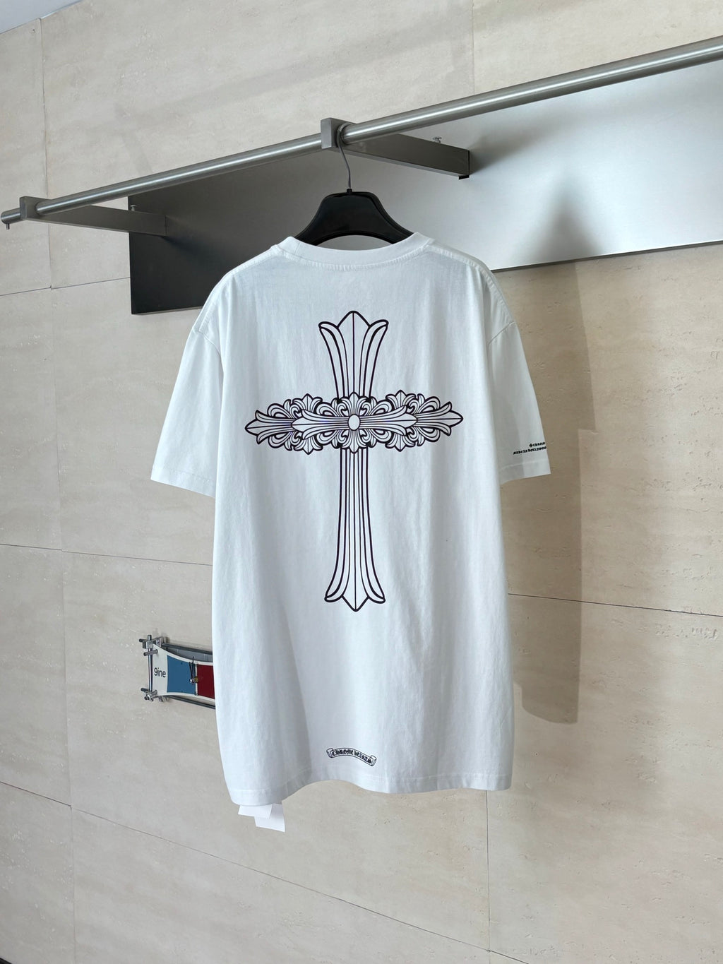 White short-sleeve T-shirt with large back ribbon-style graphic and crew neck.