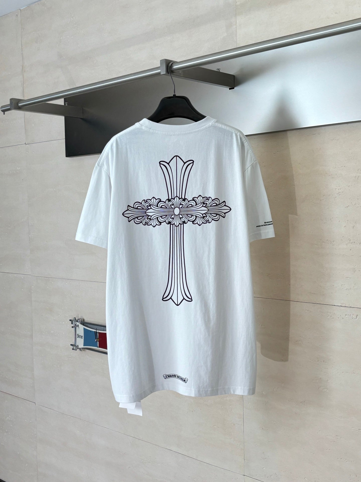 Back of short-sleeve T-shirt with large cross-and-flowers graphic, white