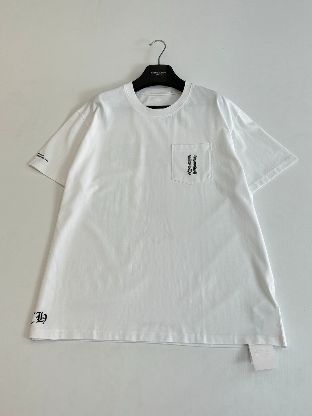 White short-sleeve T-shirt on hanger, crew neck, small front chest logo