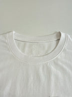 White crew-neck T-shirt neckline with subtle embossed logo detail.
