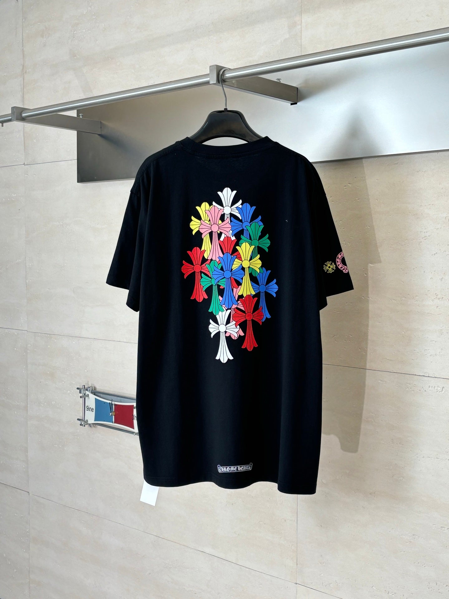 Black short-sleeve T-shirt with large multicolor floral graphic on the back