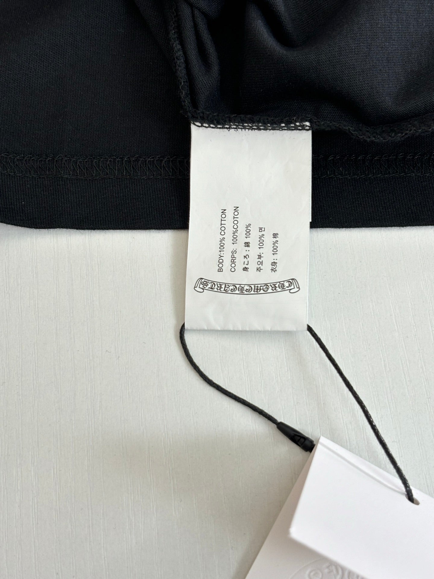Black shorts fabric with waistband and internal size label close-up