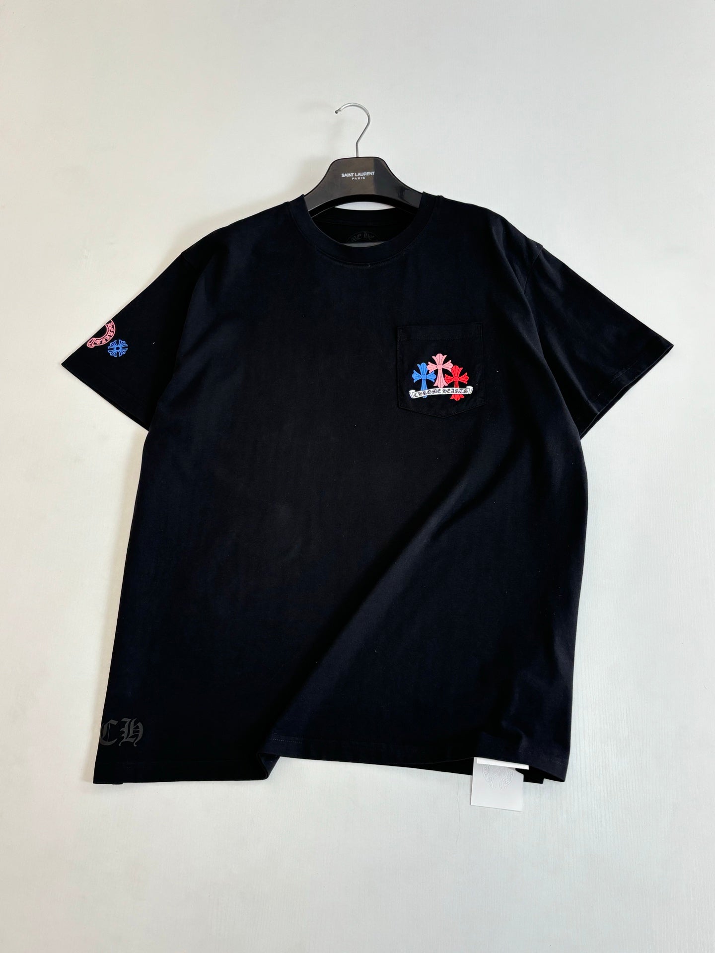 Black short-sleeve T-shirt with chest graphic and small sleeve emblem