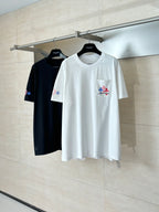 White and black short-sleeve T-shirts on hangers, each with multicolor logo accents.
