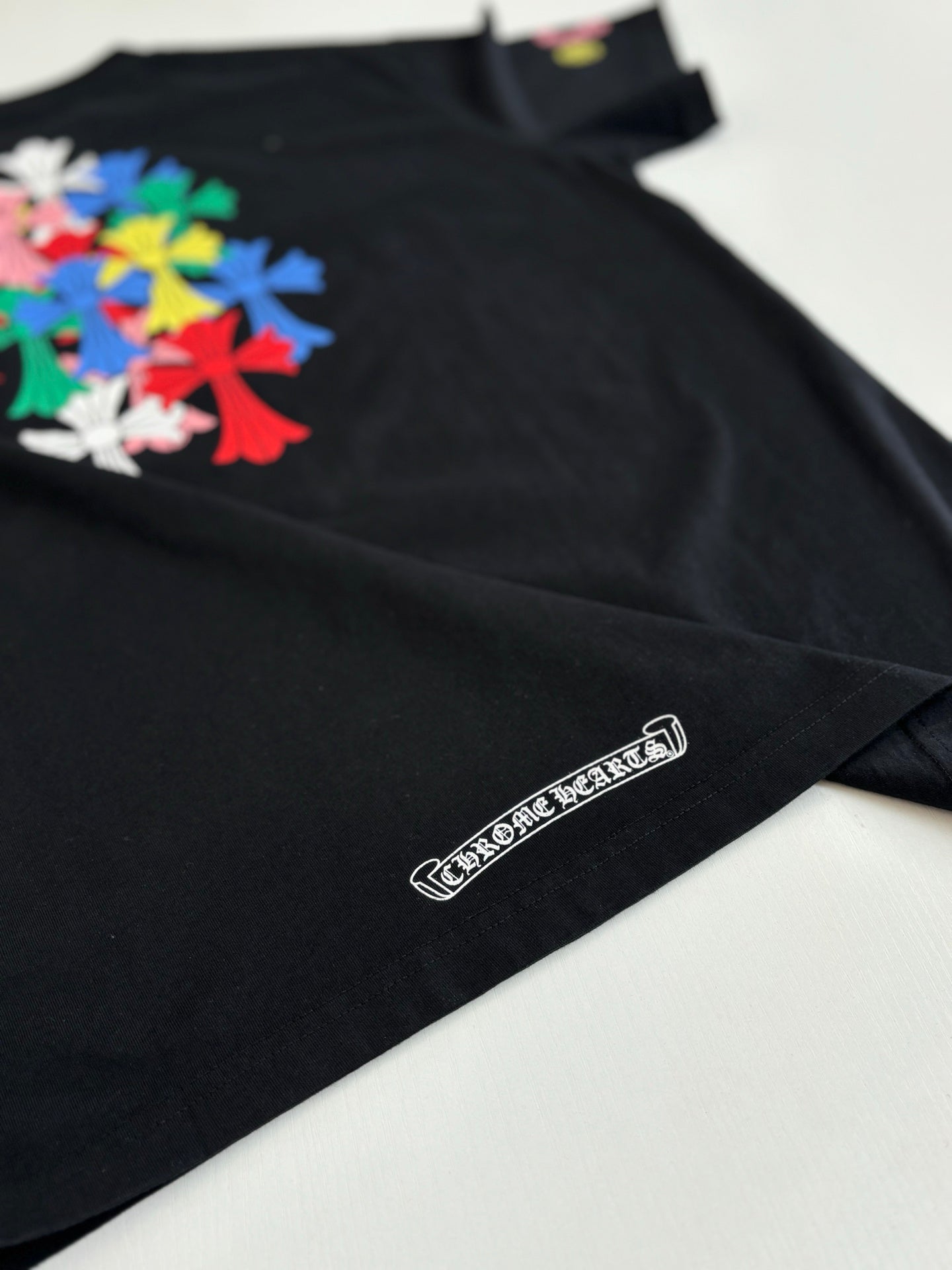 Black short-sleeve T-shirt with small logo label near the hem.