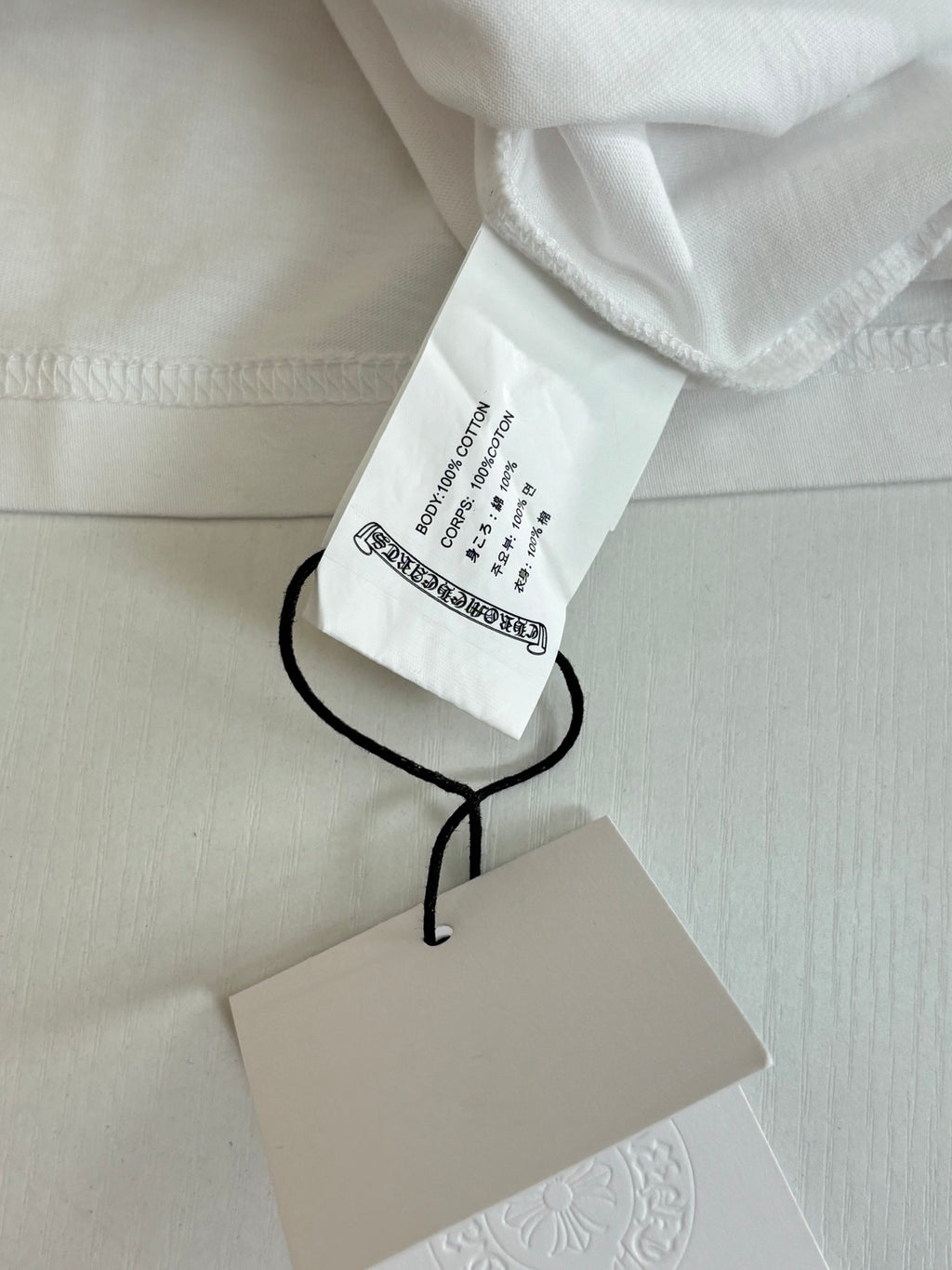 White Chrome short with attached hang tag and black drawstring