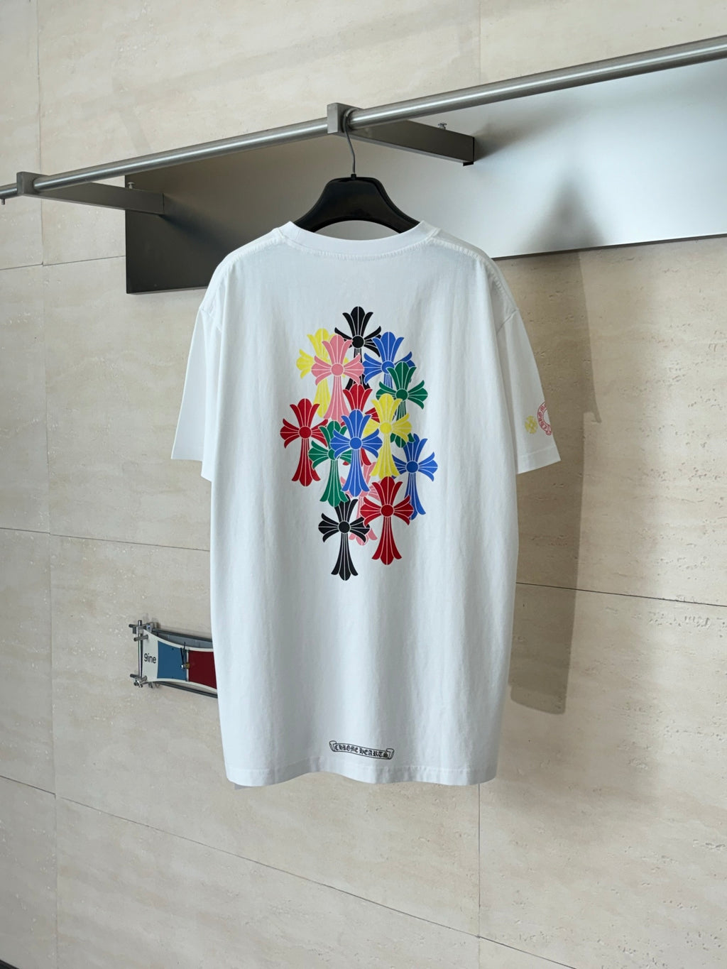White T-shirt with large colorful flower graphic on the back