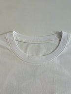 White crew-neck T-shirt collar with subtle embossed logo detail