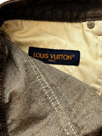 Beige waistband lining with LOUIS VUITTON Paris label on dark denim pants
