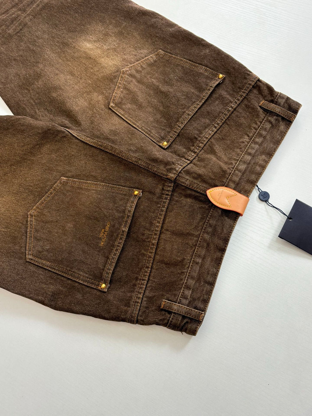 Louis Vuitton brown denim pants layout, back pockets and buttoned waistband