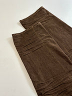 Louis Vuitton brown denim pants laid flat, visible front fly and stitching