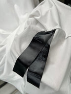 Balenciaga white T-shirt with black logo tag detail near neckline