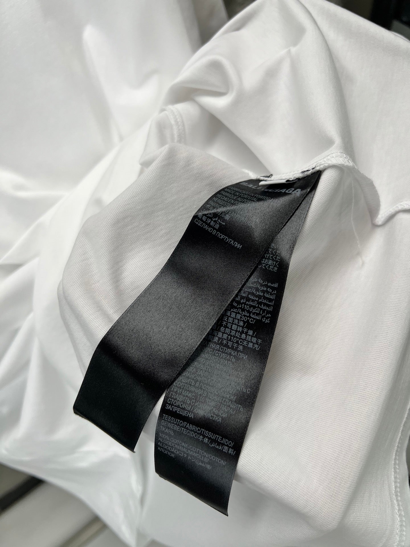 Balenciaga white T-shirt with black logo tag detail near neckline