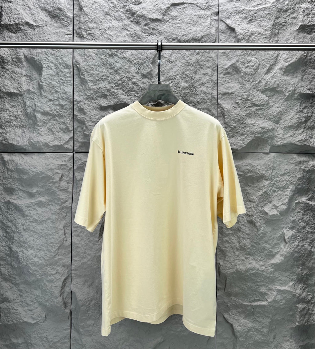 Balenciaga short-sleeve T-shirt, pale yellow crew neck with small chest logo.