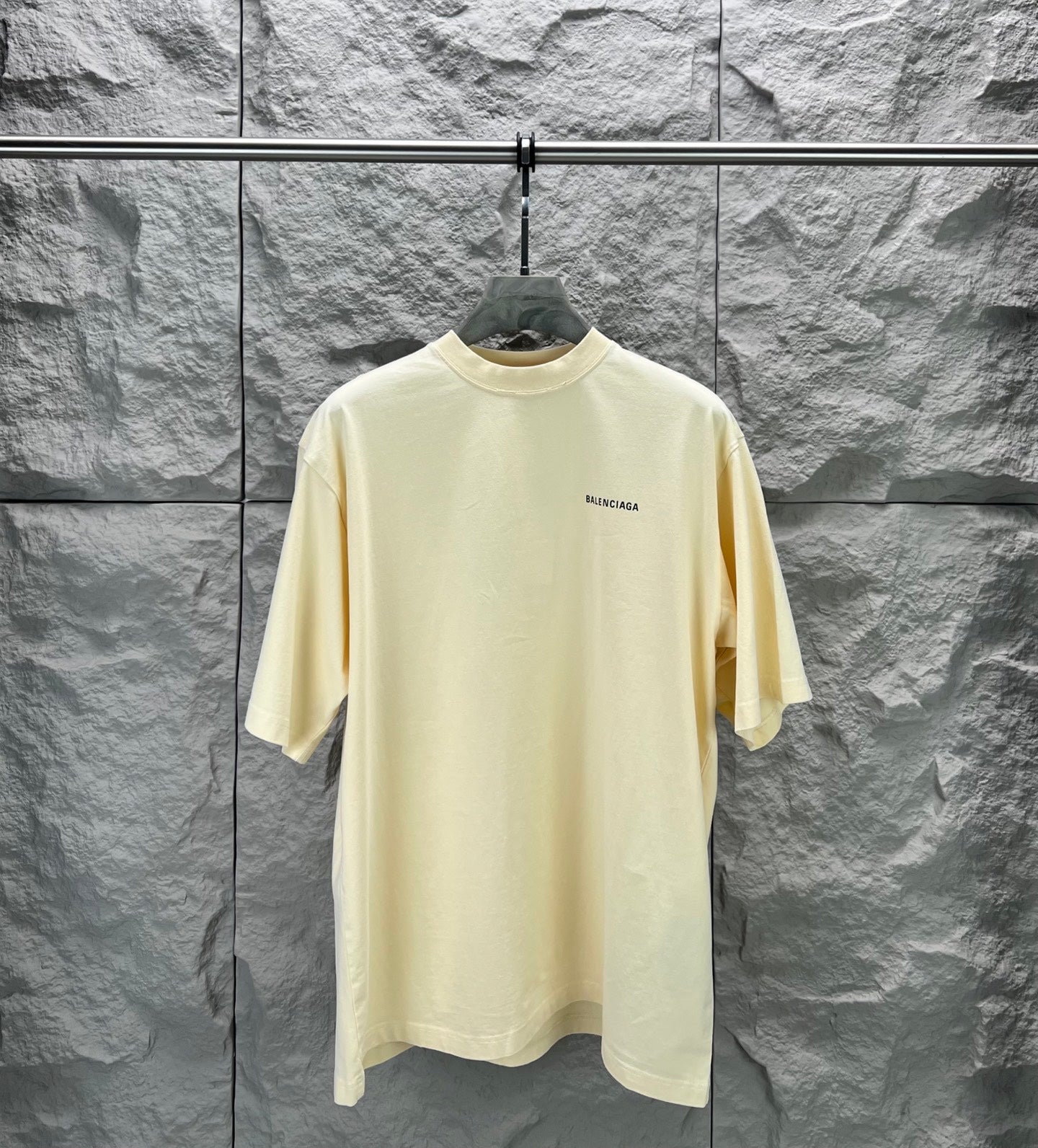 Balenciaga short-sleeve T-shirt, pale yellow crew neck with small chest logo.