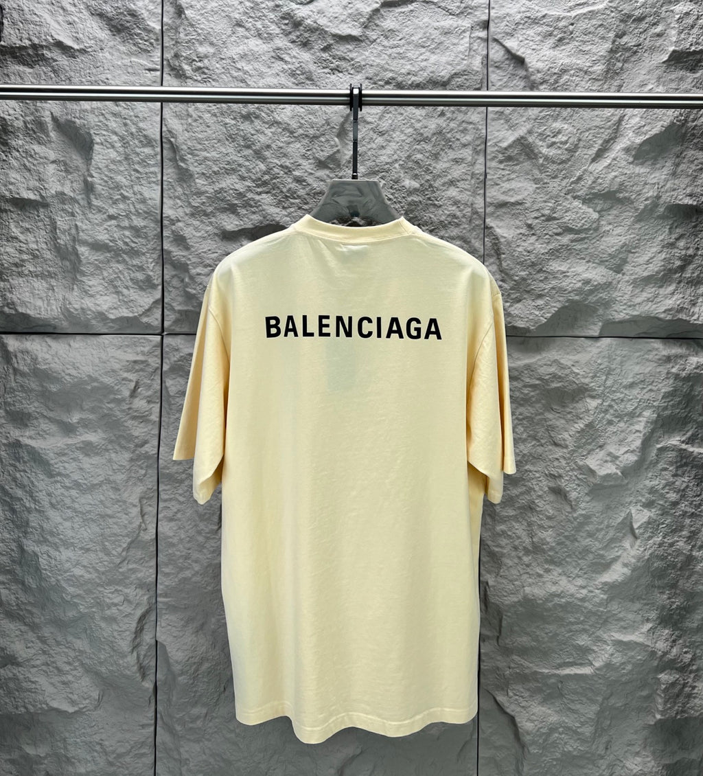 Cream short-sleeve T-shirt with large BALENCIAGA logo across upper back.