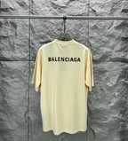 Cream short-sleeve T-shirt with large BALENCIAGA logo across upper back.