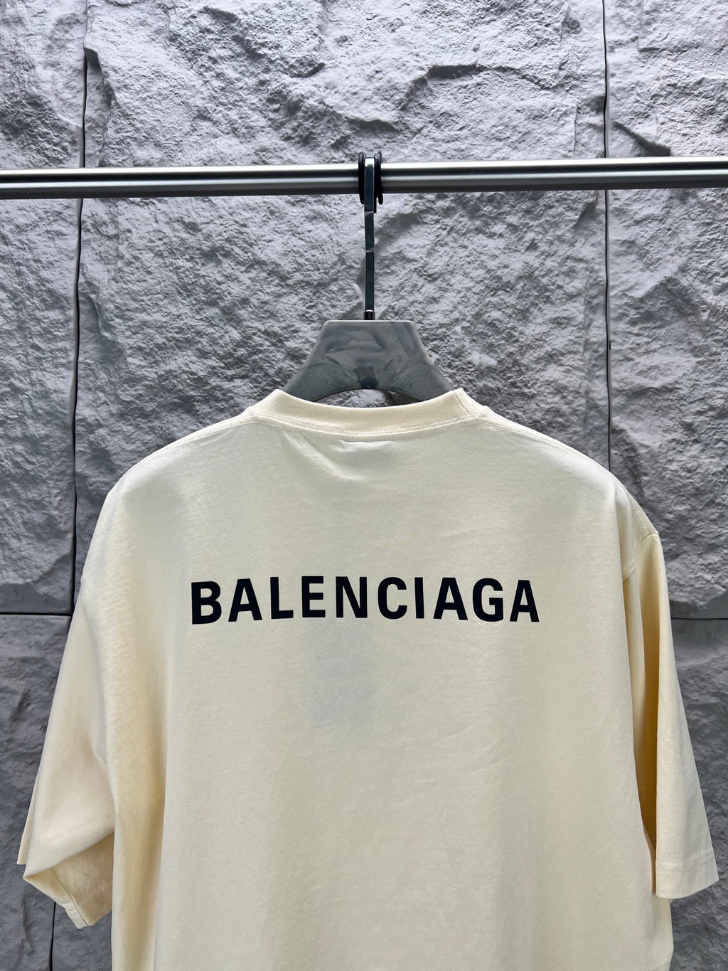 Cream short-sleeve T-shirt with large BALENCIAGA logo centered on upper back.