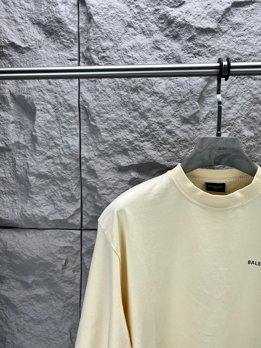 Cream short-sleeve T-shirt, crew neck with small BALENCIAGA logo at right chest.