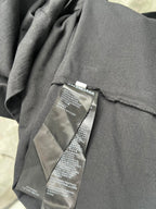 Balenciaga T-shirt care label stitched on gray fabric near seam
