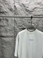 White crew-neck T-shirt with small Balenciaga logo on chest, close view