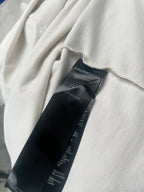 Black inner clothing label with Balenciaga branding on white T-shirt