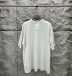 White crew-neck T-shirt on hanger with small Balenciaga logo on chest