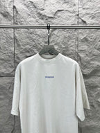 White crew-neck T-shirt with small Balenciaga logo on chest, front view